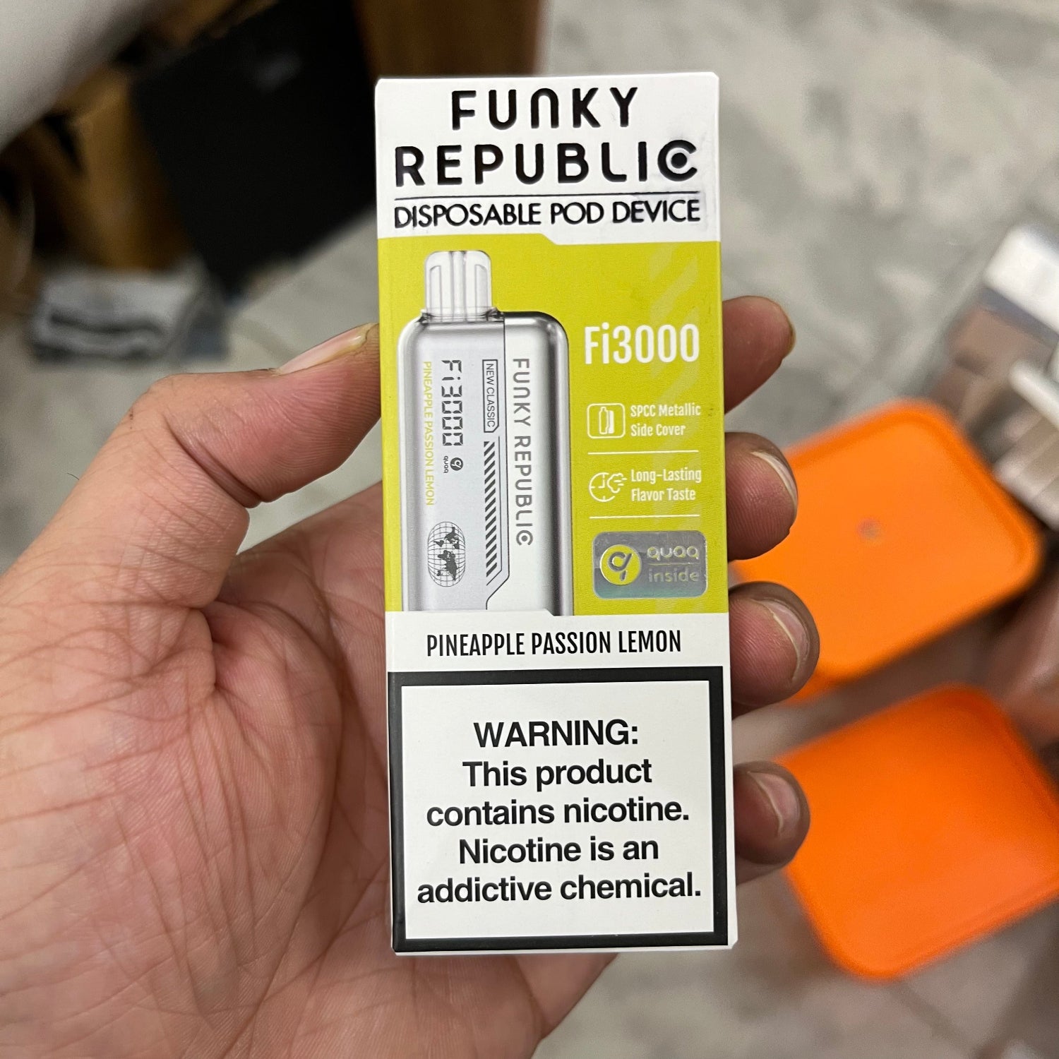 Funky Republic disposable pod device packaging held in a hand with a blurred background
