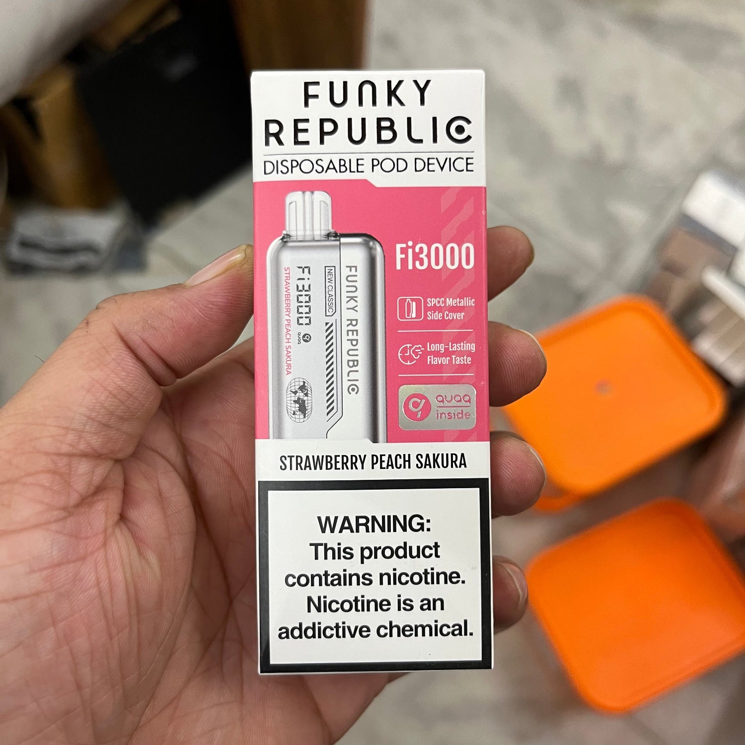 Hand holding a 'Funky Republic' disposable pod device packaging with a warning label.